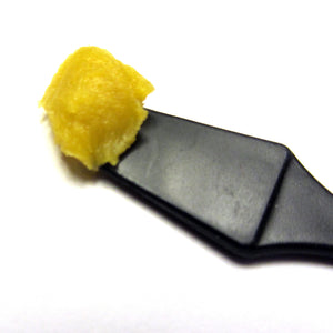 PCR Hemp CBD-infused Rescue Balm close up on spatula to show balm color and texture by THE WILDNESS
